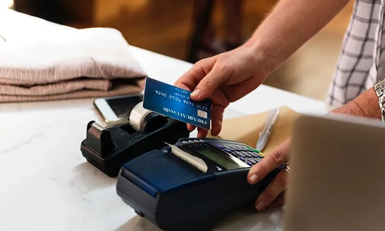 A man swiping a credit card for payment