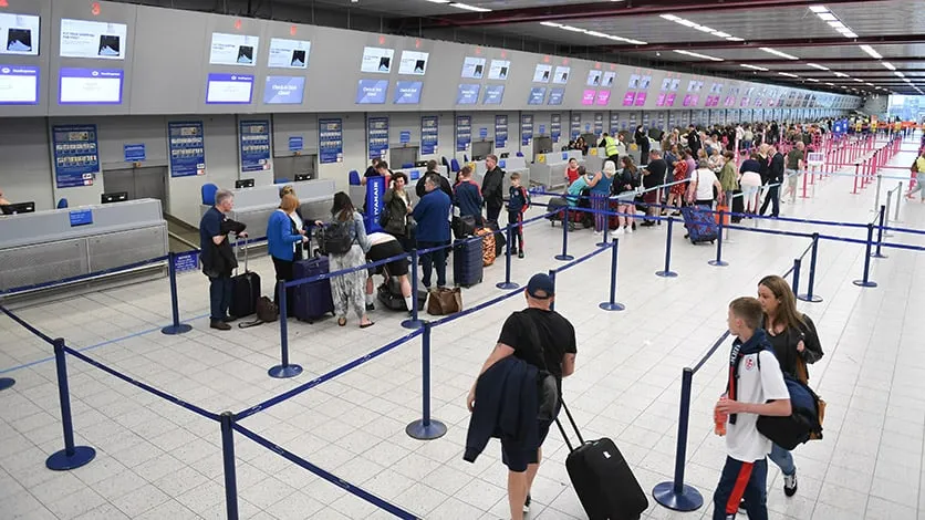 People standing in the check-in line at airport