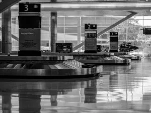 Baggage claims inside an airport in black and white