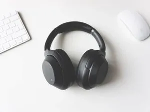 Black bluetooth headphones on a white table