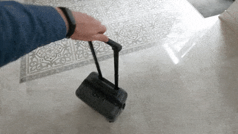 chester luggage testing the moveability of spinner wheels