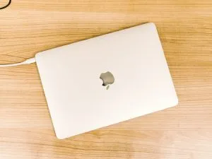 A closed Apple laptop on a table