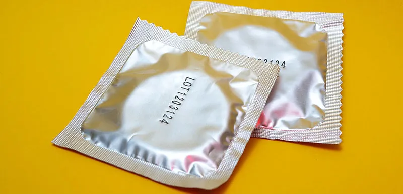 Condoms on a yellow background