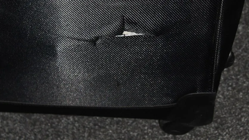 Damaged fabric suitcase