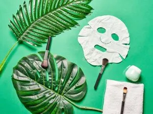 Face sheet mask on a green background