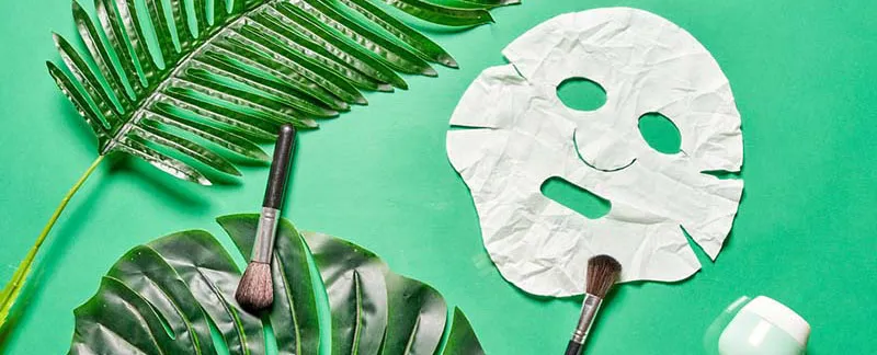 Face sheet mask on a green background