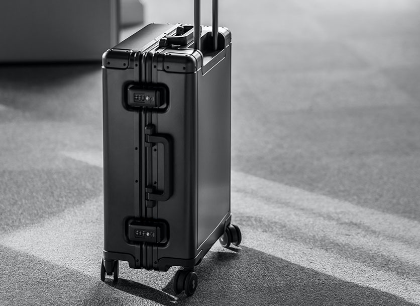 A gray zipperless aluminum hardside suitcase