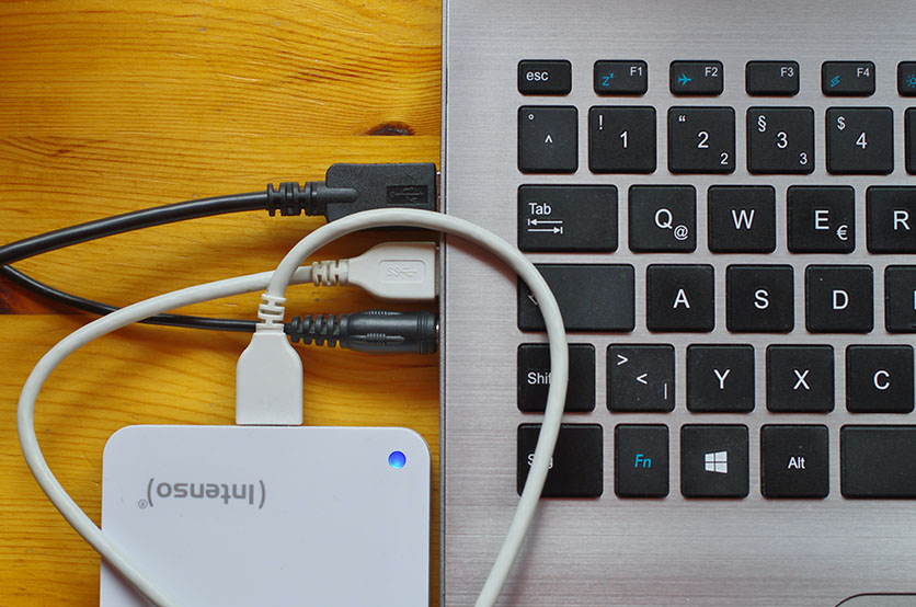 A hard drive plugges into a laptop