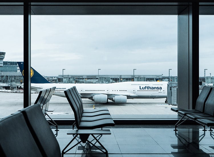 lufthansa airplane sitting at the boarding gate
