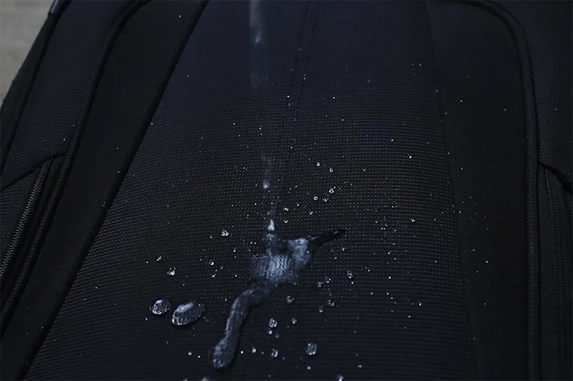 Pouring water on the Travelpro Maxlite 5 polyester fabric with duraguard coating