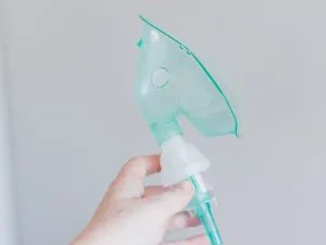 Nebulizer inhaler tube held in hand