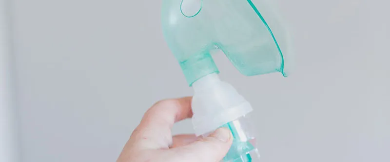 Can You Bring Nebulizers on Planes? 1 Nebulizer inhaler tube held in hand