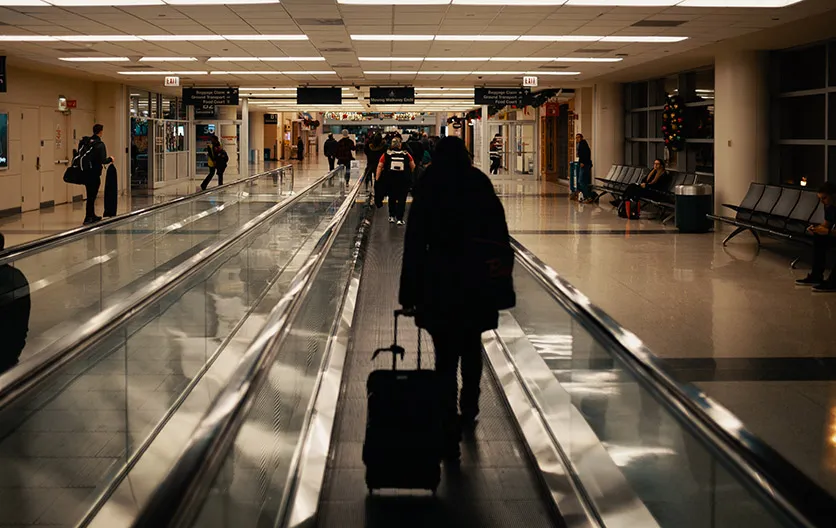 Passengers walking to gates in a large airport