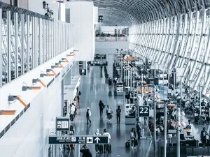 People waiting for their flights at the gates inside an airport