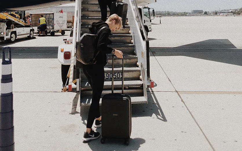 A person traveling only with a carry-on and a backpack
