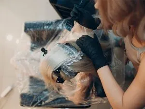 A woman applying hair dye