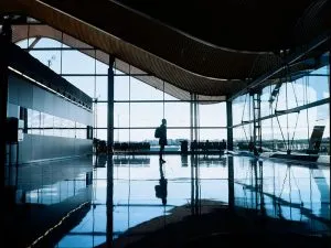 a woman standing alone inside an airport